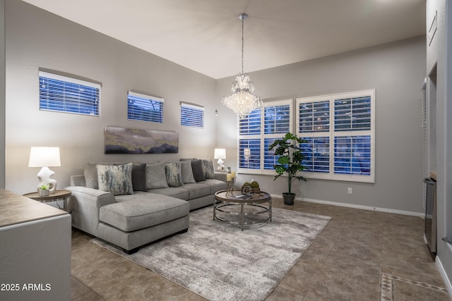 living room with an inviting chandelier, tile patterned flooring, and baseboards