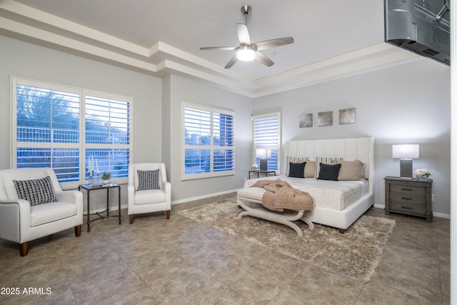 bedroom featuring a tray ceiling, baseboards, and a ceiling fan