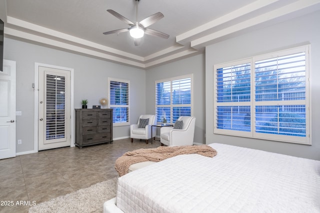 bedroom with access to exterior, a tray ceiling, baseboards, and ceiling fan