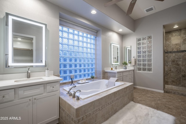 full bathroom with visible vents, ceiling fan, a sink, and a garden tub