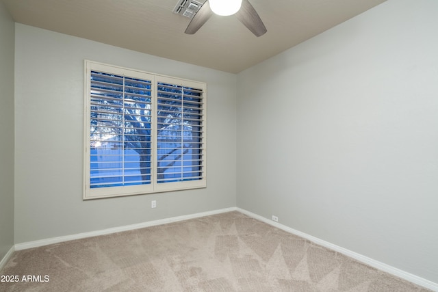 carpeted spare room with a ceiling fan, baseboards, and visible vents