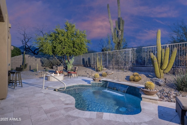 view of pool with a fenced backyard and a patio