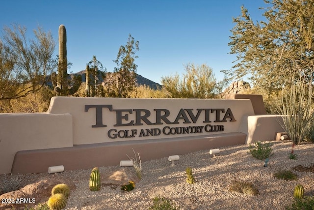 community sign with a mountain view