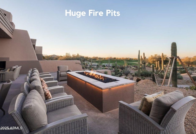view of patio / terrace with an outdoor living space with a fire pit