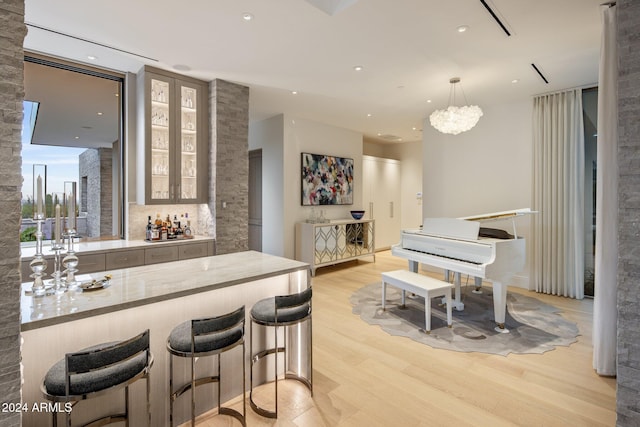 bar featuring light hardwood / wood-style flooring