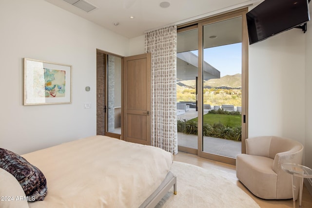 bedroom featuring access to exterior and a mountain view