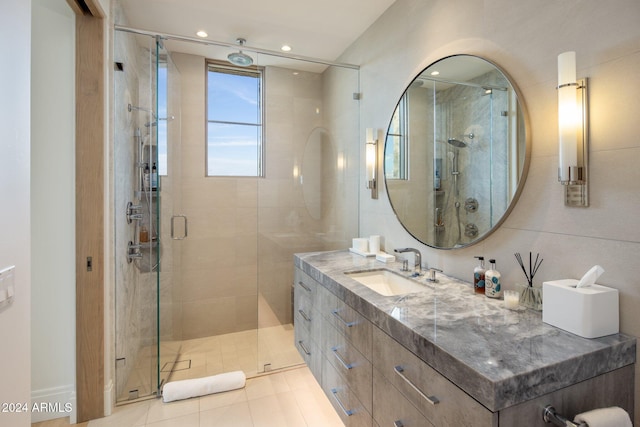 bathroom featuring vanity, tile patterned floors, and a shower with shower door