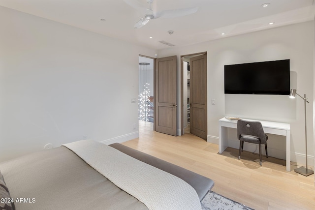 bedroom with ceiling fan and light hardwood / wood-style floors