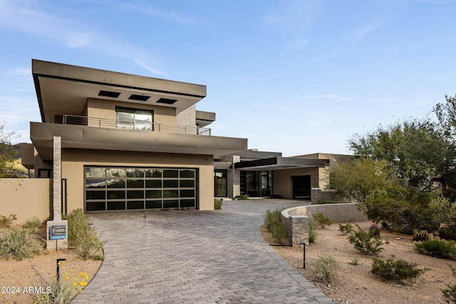 contemporary home featuring a balcony and a garage