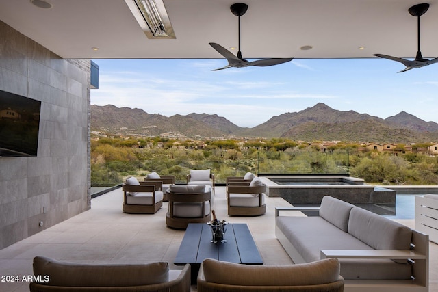 view of patio with a mountain view, an outdoor hangout area, and ceiling fan