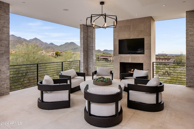 view of patio featuring an outdoor living space with a fireplace