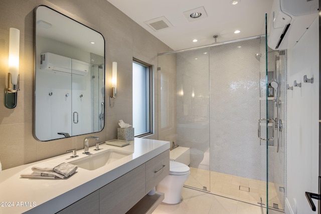 bathroom featuring tile patterned flooring, vanity, toilet, and walk in shower