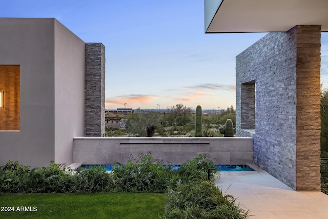 view of patio terrace at dusk