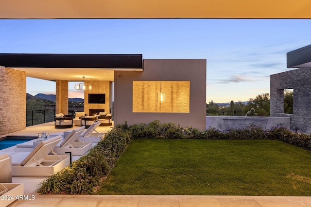 view of front of house with a patio area, an outdoor hangout area, and a front yard