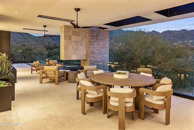 view of patio featuring a mountain view and ceiling fan