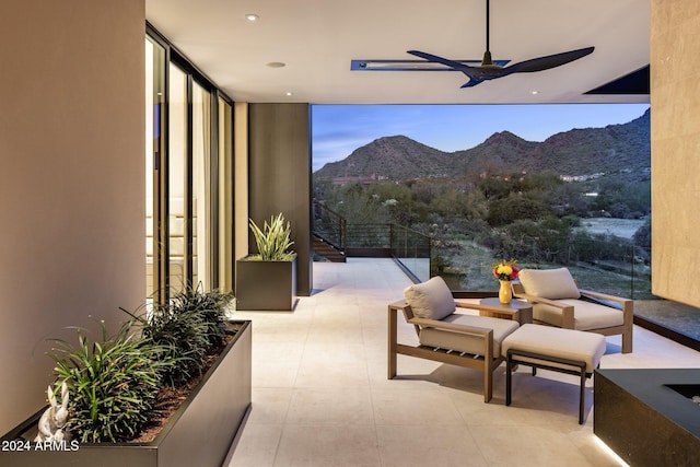 interior space featuring a mountain view and ceiling fan