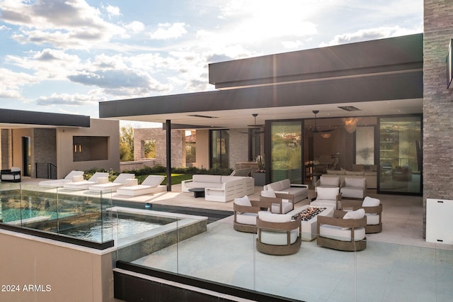 view of patio / terrace with an outdoor living space with a fire pit