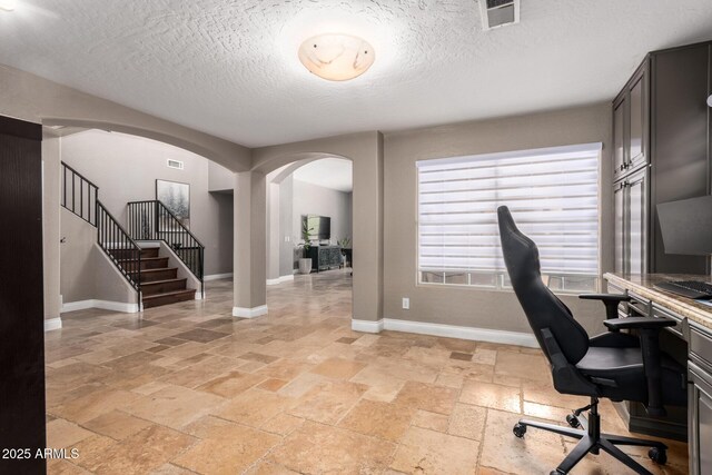 1751 W Mulberry Dr, Chandler, AZ 85286 - office with arched walkways, stone tile flooring, and a textured ceiling