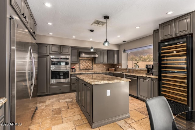 1751 W Mulberry Dr, Chandler, AZ 85286 - kitchen featuring appliances with stainless steel finishes, beverage cooler, stone tile floors, tasteful backsplash, and recessed lighting