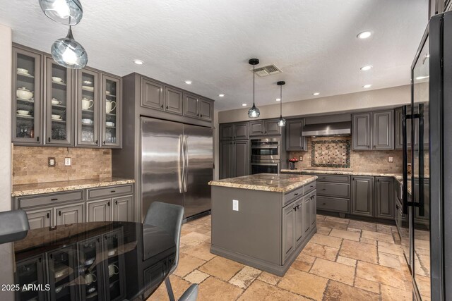 1751 W Mulberry Dr, Chandler, AZ 85286 - kitchen featuring appliances with stainless steel finishes, gray cabinetry, stone tile flooring, recessed lighting, and a kitchen island