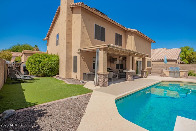 1751 W Mulberry Dr, Chandler, AZ 85286 - rear view of house with area for grilling, a fenced backyard, a patio, stucco siding, and a tiled roof