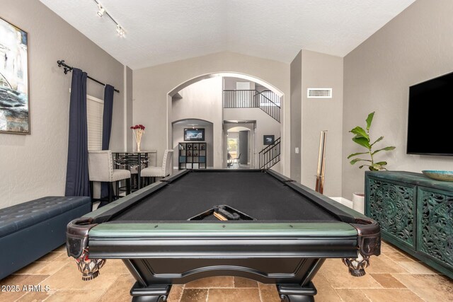 1751 W Mulberry Dr, Chandler, AZ 85286 - game room featuring arched walkways, billiards table, vaulted ceiling, and stone tile flooring
