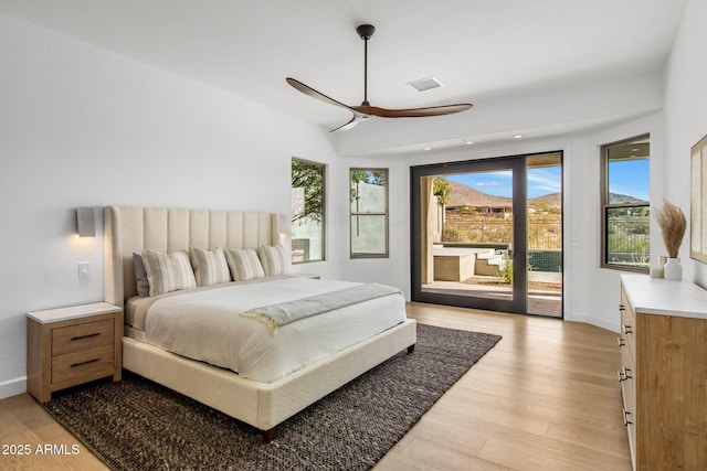 bedroom with access to outside, visible vents, light wood-style flooring, and baseboards