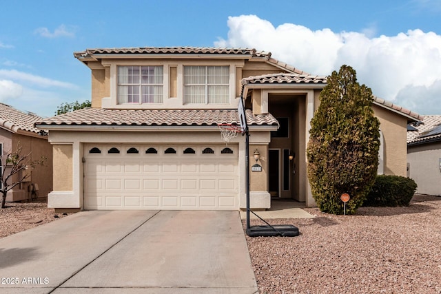 mediterranean / spanish house featuring concrete driveway, an attached garage, and stucco siding