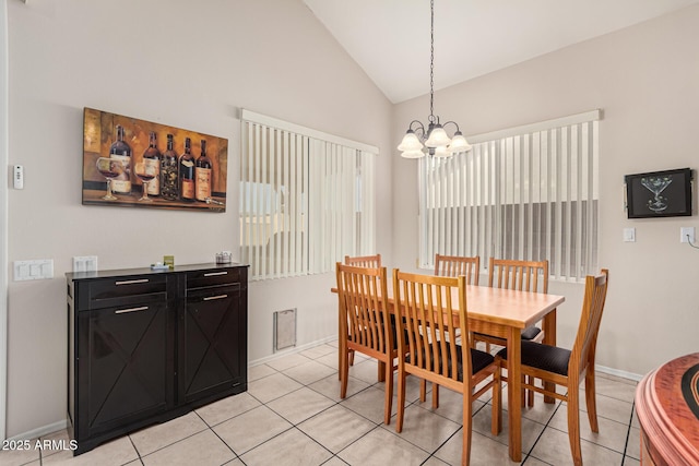 dining room with baseboards, vaulted ceiling, a notable chandelier, and light tile patterned flooring