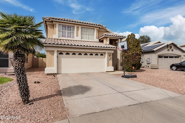 mediterranean / spanish-style house with a tile roof, stucco siding, concrete driveway, roof mounted solar panels, and a garage