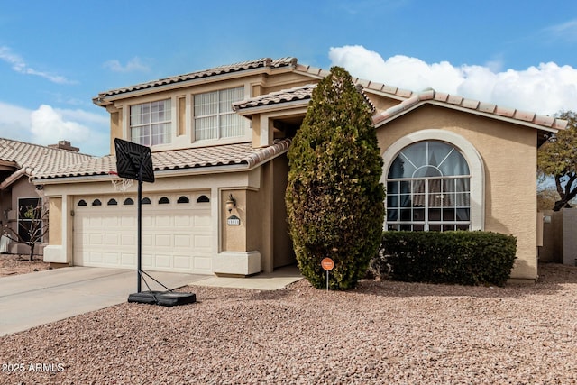 mediterranean / spanish home with concrete driveway and stucco siding