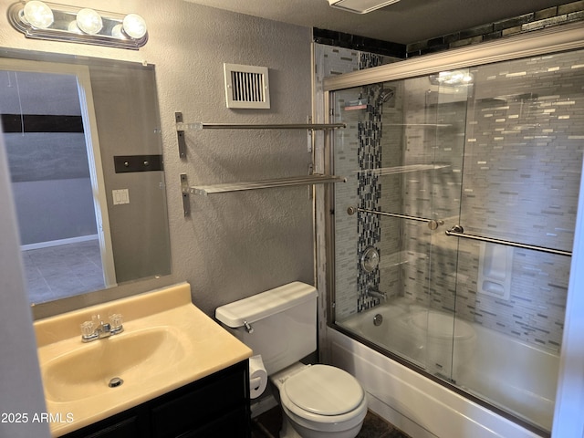 bathroom featuring vanity, a textured wall, visible vents, and enclosed tub / shower combo