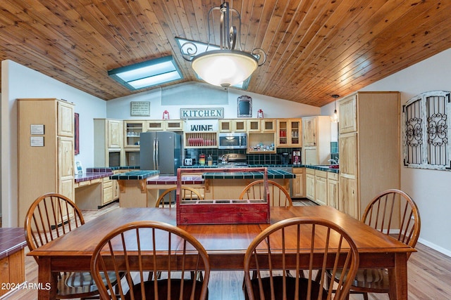 dining space featuring lofted ceiling with skylight, wood ceiling, and wood-type flooring