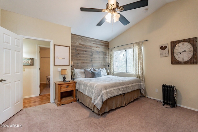 bedroom featuring ceiling fan, light carpet, vaulted ceiling, and radiator