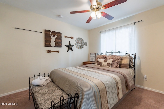 bedroom featuring ceiling fan and dark colored carpet