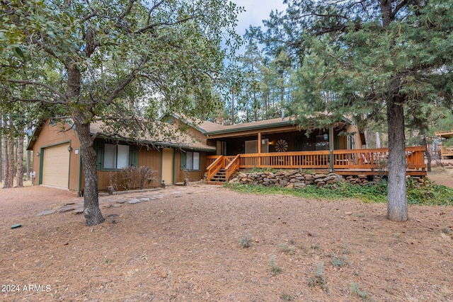 view of front facade featuring a deck and a garage