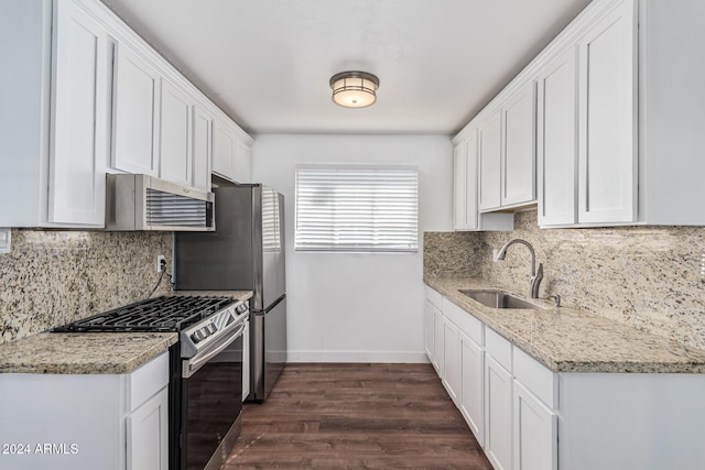 kitchen with dark wood-type flooring, sink, white cabinets, appliances with stainless steel finishes, and light stone counters