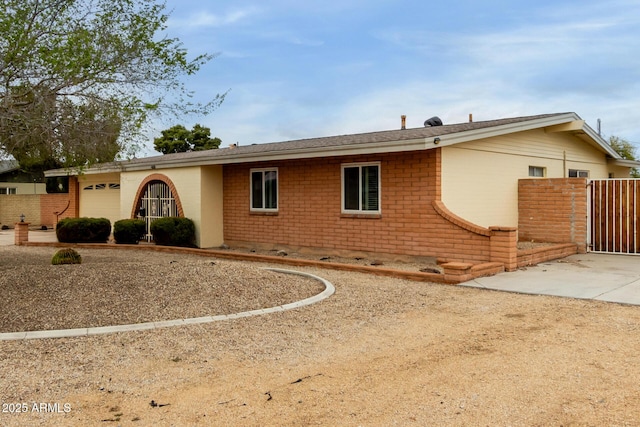 single story home featuring brick siding and fence