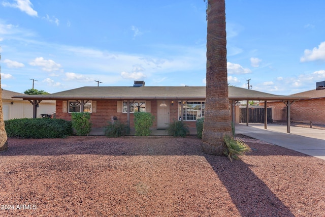 ranch-style home featuring a carport