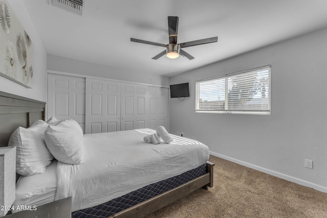 carpeted bedroom featuring ceiling fan and a closet