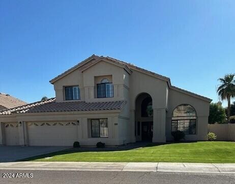 mediterranean / spanish house featuring a balcony and a front yard