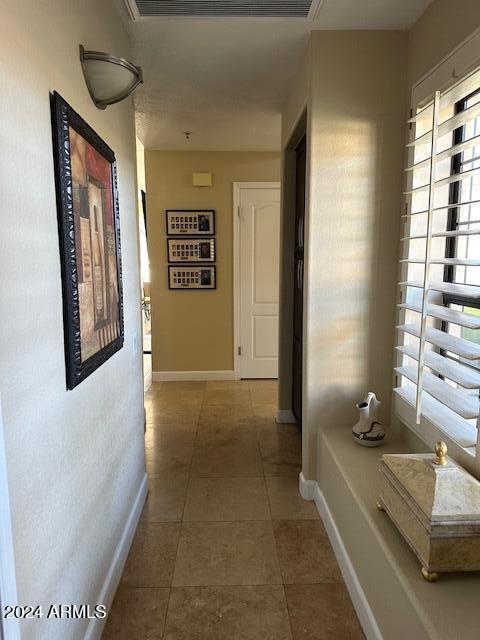 corridor with dark tile patterned flooring