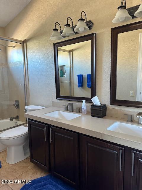 full bathroom with tile patterned flooring, vanity, bathing tub / shower combination, and toilet