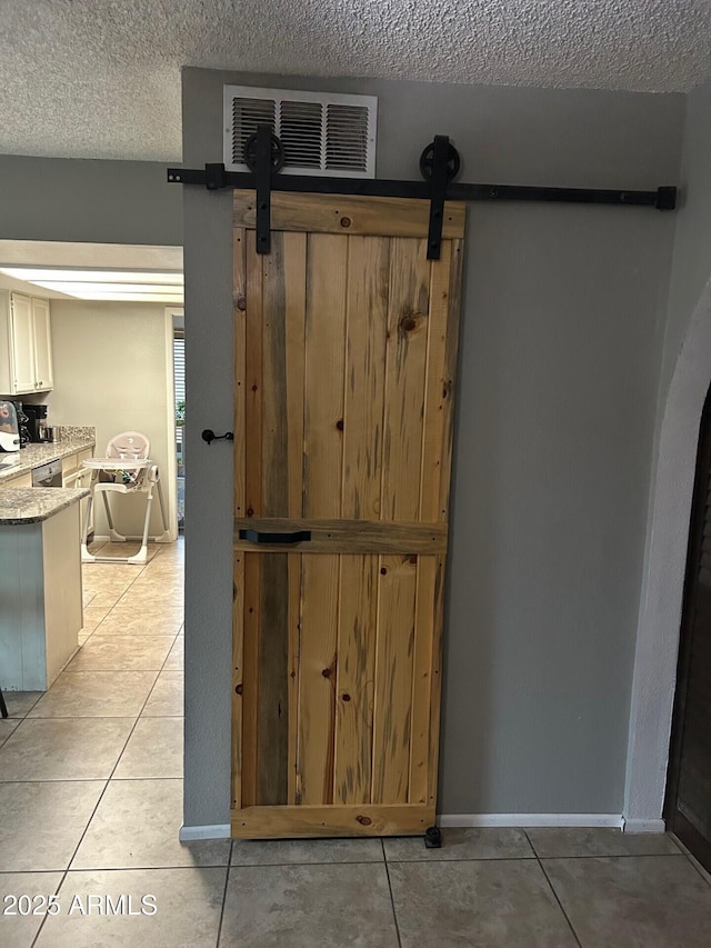 5143 W Mountain View Rd, Glendale, AZ 85302 - detailed view of a barn door, a textured ceiling, and baseboards