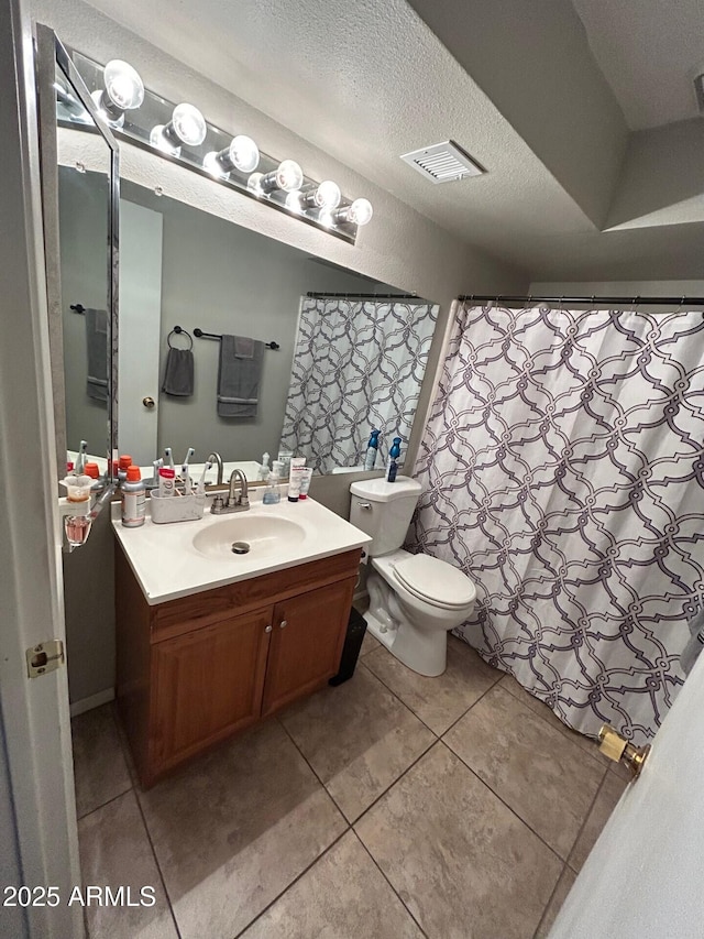 5143 W Mountain View Rd, Glendale, AZ 85302 - full bathroom with toilet, tile patterned flooring, vanity, and a textured ceiling