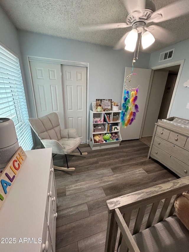 5143 W Mountain View Rd, Glendale, AZ 85302 - bedroom featuring a closet, dark wood finished floors, a textured ceiling, and a ceiling fan