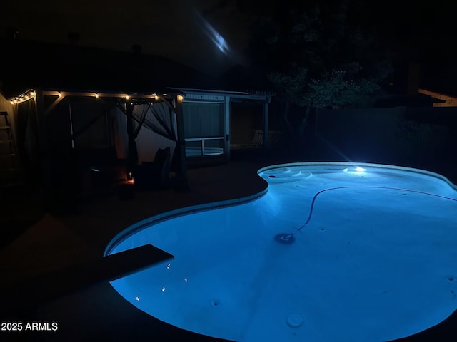 5143 W Mountain View Rd, Glendale, AZ 85302 - pool at night with a patio area and an outdoor pool