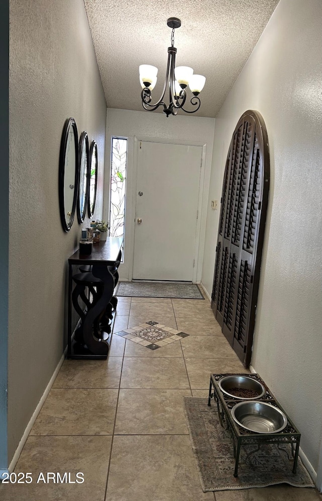 5143 W Mountain View Rd, Glendale, AZ 85302 - entryway with a textured ceiling, a chandelier, tile patterned floors, and a textured wall
