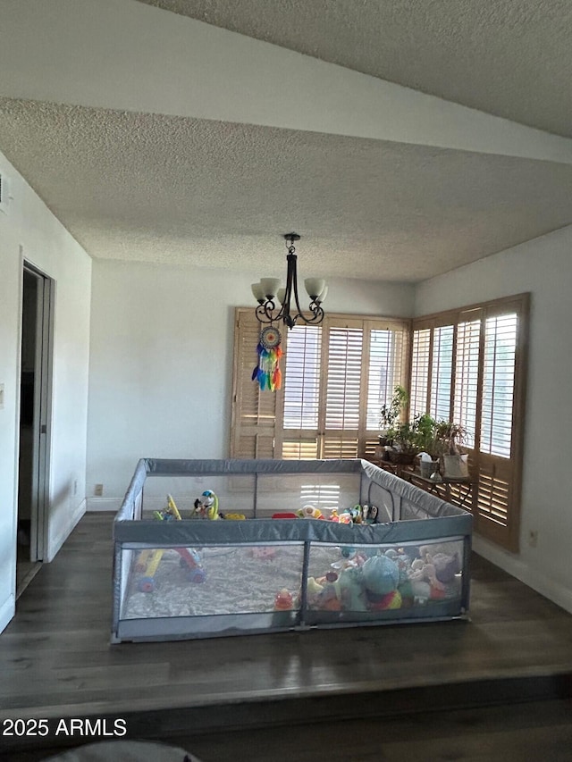 5143 W Mountain View Rd, Glendale, AZ 85302 - detailed view of wood finished floors, baseboards, a textured ceiling, and a chandelier