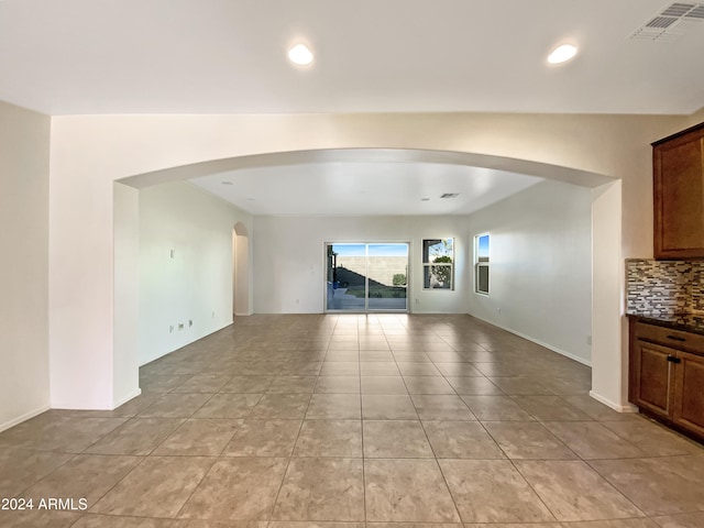 unfurnished living room featuring light tile patterned floors